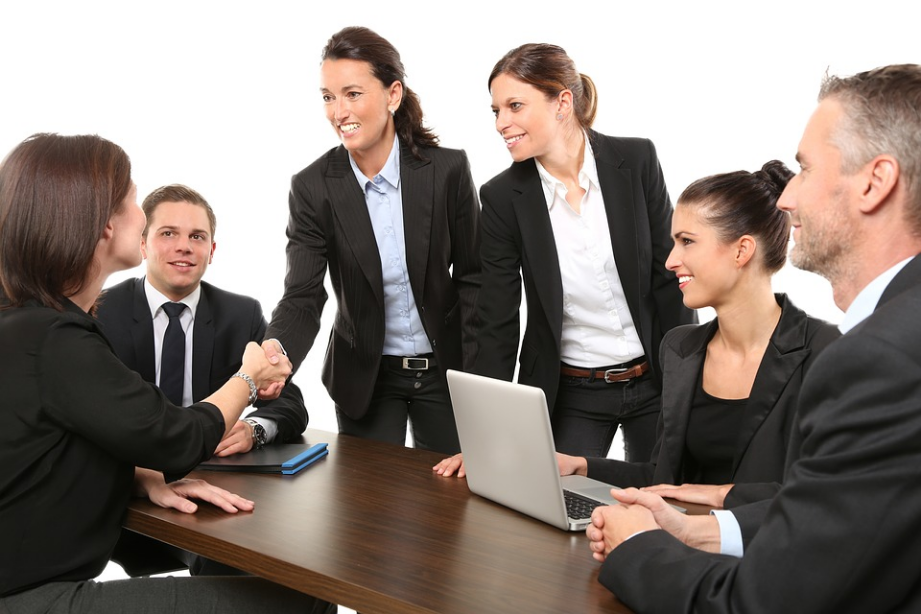 a group of office workers meeting in a room